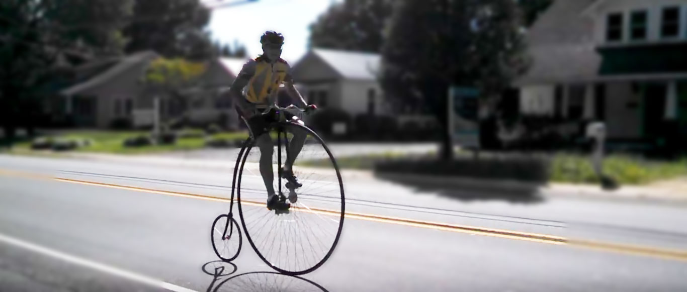 Video: A guy rides a high wheeler down the main street...